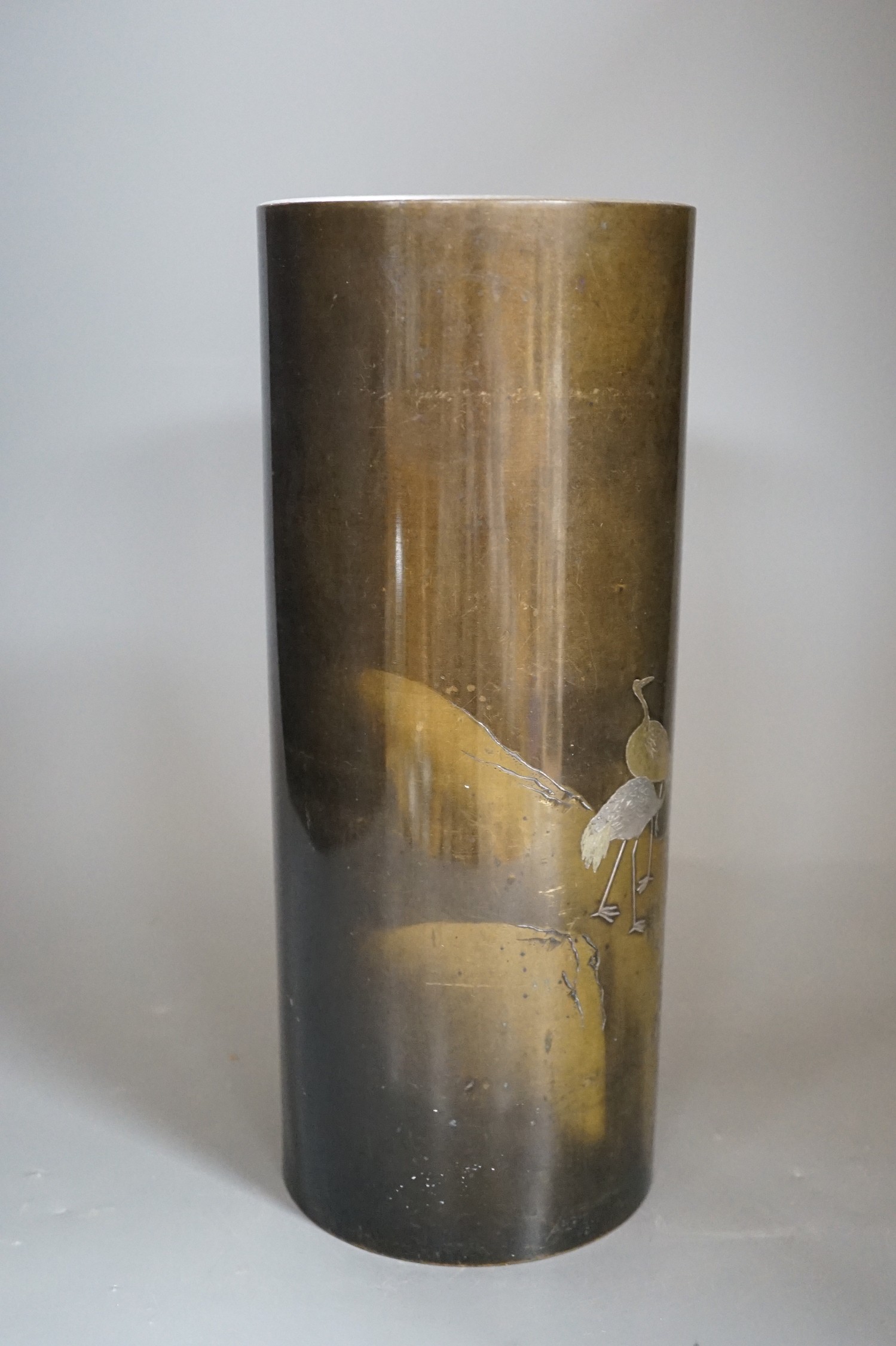 A Japanese mixed metal inlaid bronze cylindrical vase, Meiji period, 30cm